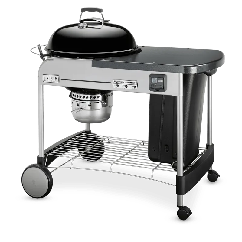 Asador de carbón negro de gran tamaño con mesa lateral y tapa, ideal para parrilla y ahumados.